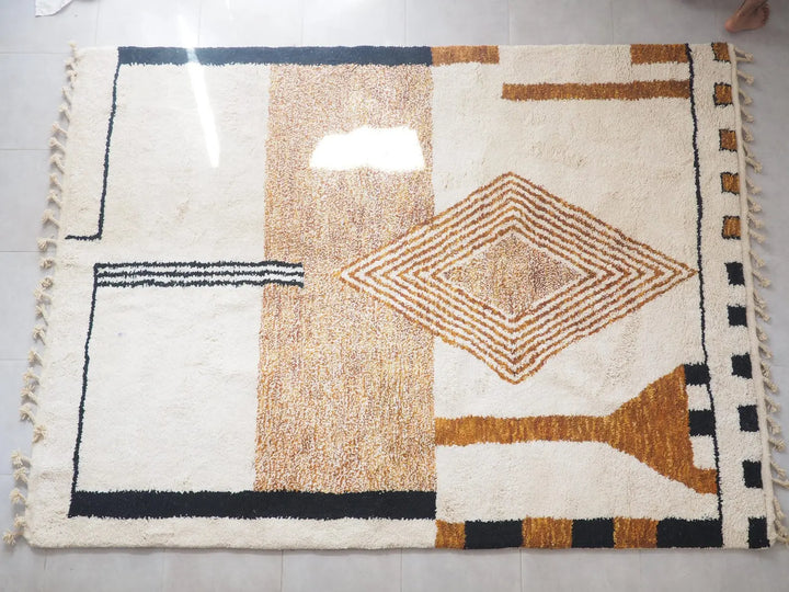 Geometric patterned rug with brown, black, and white colors on a plain background