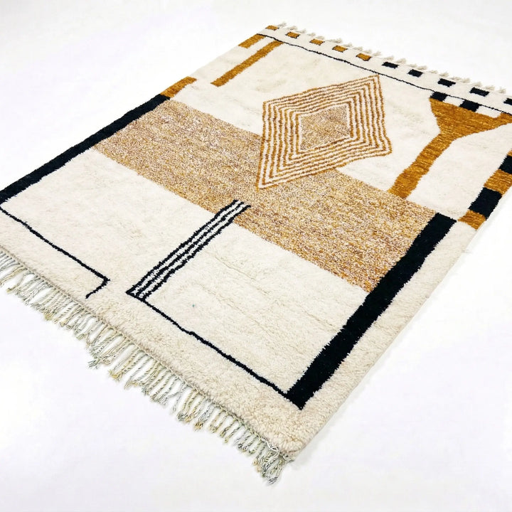 Geometric patterned rug with fringes on a white background