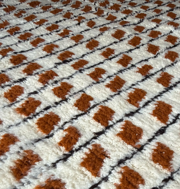 Close-up of a textured fabric with brown and black pattern