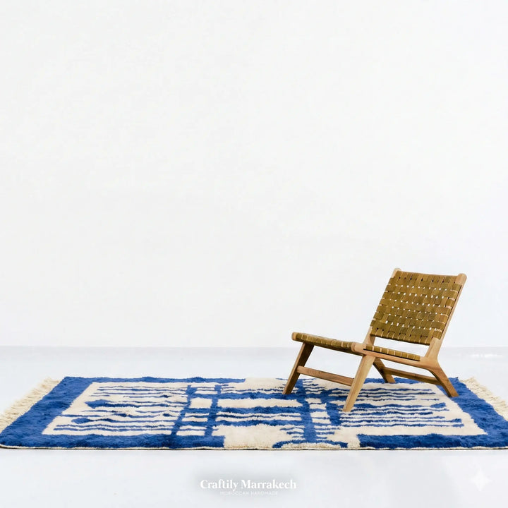 Authentic handmade Moroccan rug in blue and white wool. Large Beni Mrirt carpet hanging on display, showing dense pile and custom geometric pattern.